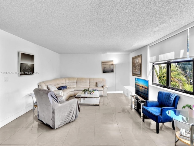 20401 NE 30th Ave Unit 310-8, Aventura, FL 33180 - tiled living room featuring a textured ceiling and baseboards