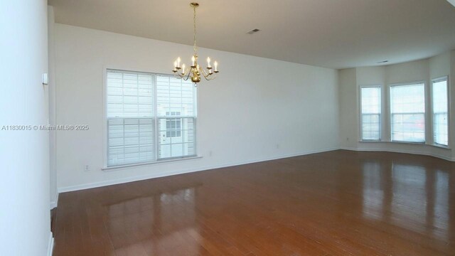 4407 Karlbrook Ln, ,, NC 27616 - spare room featuring wood finished floors and a chandelier