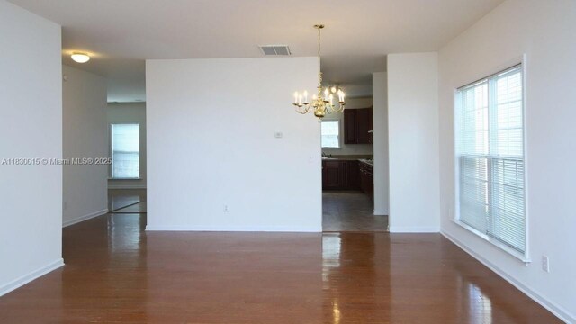 4407 Karlbrook Ln, ,, NC 27616 - unfurnished room featuring a chandelier and dark wood-type flooring