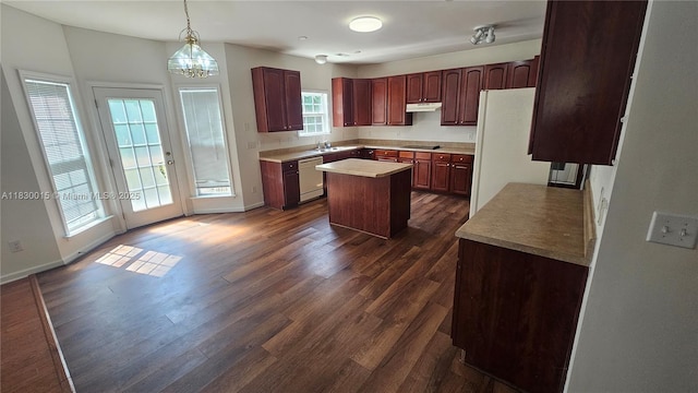 4407 Karlbrook Ln, ,, NC 27616 - kitchen with white appliances, a center island, dark wood-style floors, under cabinet range hood, and light countertops