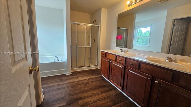 4407 Karlbrook Ln, ,, NC 27616 - full bathroom with wood finished floors, a shower stall, double vanity, and a garden tub