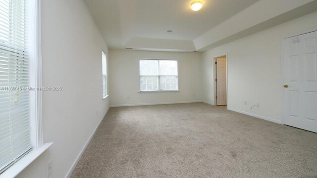 4407 Karlbrook Ln, ,, NC 27616 - unfurnished bedroom featuring carpet floors and a tray ceiling