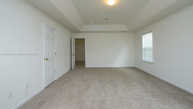 4407 Karlbrook Ln, ,, NC 27616 - spare room featuring a raised ceiling and light carpet
