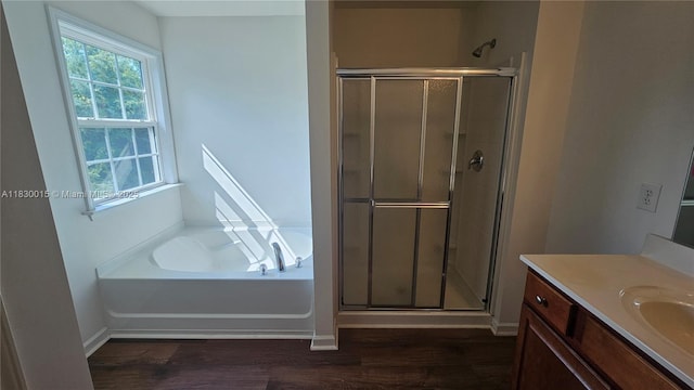 4407 Karlbrook Ln, ,, NC 27616 - bathroom featuring vanity, a shower stall, a garden tub, and wood finished floors