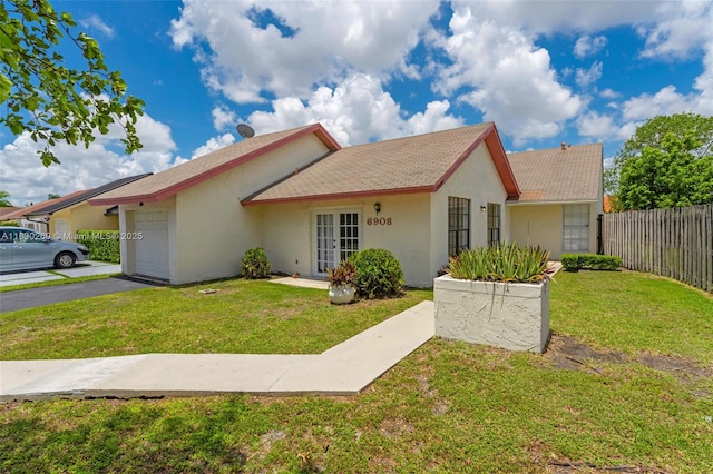 6908 SW 104th Ct, Miami, FL 33173 - view of front of house featuring french doors, an attached garage, stucco siding, and asphalt driveway