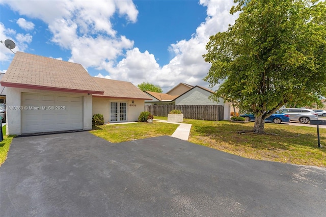 6908 SW 104th Ct, Miami, FL 33173 - view of front facade with french doors, a garage, stucco siding, and driveway