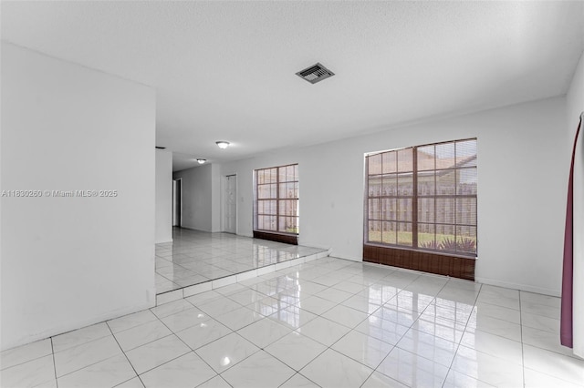 6908 SW 104th Ct, Miami, FL 33173 - empty room featuring plenty of natural light and light tile patterned flooring