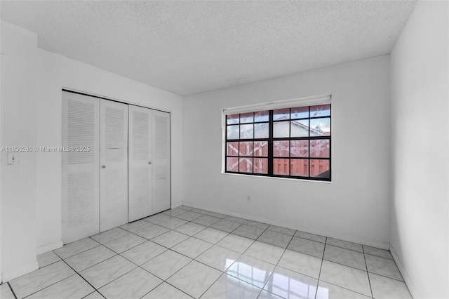 6908 SW 104th Ct, Miami, FL 33173 - unfurnished bedroom featuring a textured ceiling and a closet