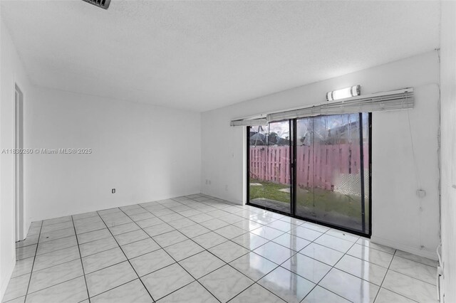 6908 SW 104th Ct, Miami, FL 33173 - unfurnished room with light tile patterned floors and a textured ceiling