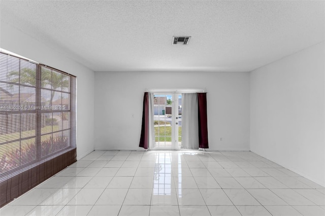 6908 SW 104th Ct, Miami, FL 33173 - spare room featuring a textured ceiling