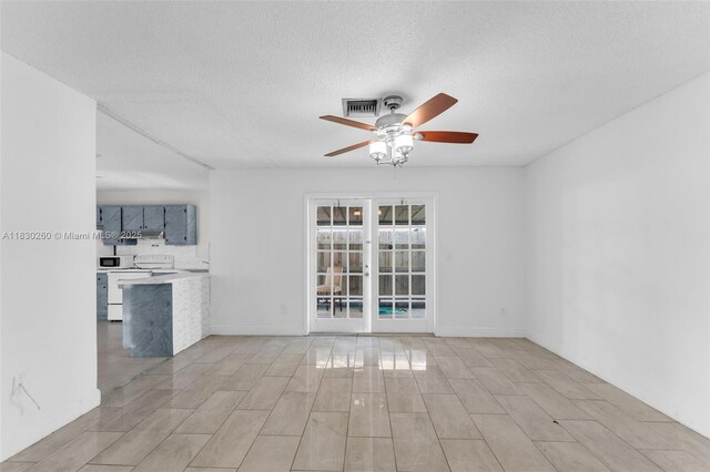 6908 SW 104th Ct, Miami, FL 33173 - unfurnished living room featuring ceiling fan, a textured ceiling, and wood finish floors