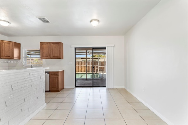 7816 Juniper St, Miramar, FL 33023 - kitchen with light countertops, brown cabinets, and light tile patterned flooring