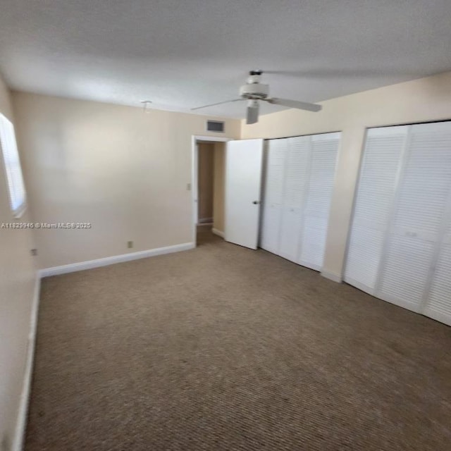 4163 NW 90th Ave Unit 206, Coral Springs, FL 33065 - unfurnished bedroom featuring two closets, carpet, and a ceiling fan