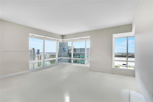 1425 Brickell Ave Unit 44A-B, Miami, FL 33131 - spare room with a view of city and baseboards