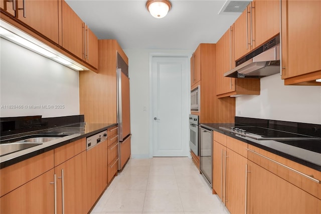 1425 Brickell Ave Unit 44A-B, Miami, FL 33131 - kitchen featuring under cabinet range hood, built in appliances, and dark countertops