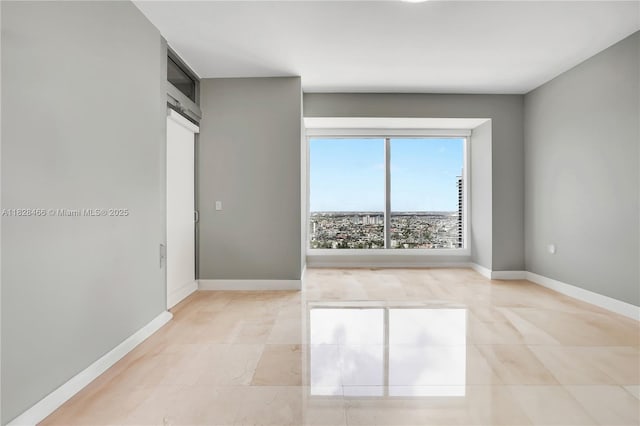 1425 Brickell Ave Unit 44A-B, Miami, FL 33131 - spare room featuring baseboards and light tile patterned floors