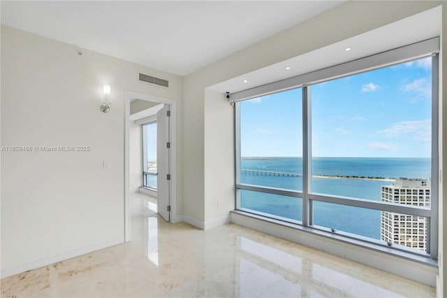 1425 Brickell Ave Unit 44A-B, Miami, FL 33131 - spare room with a water view and marble finish flooring