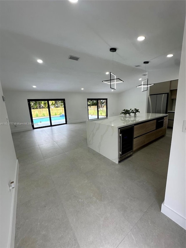 17902 SW 87th Pl, Palmetto Bay, FL 33157 - kitchen with beverage cooler, open floor plan, modern cabinets, recessed lighting, and plenty of natural light