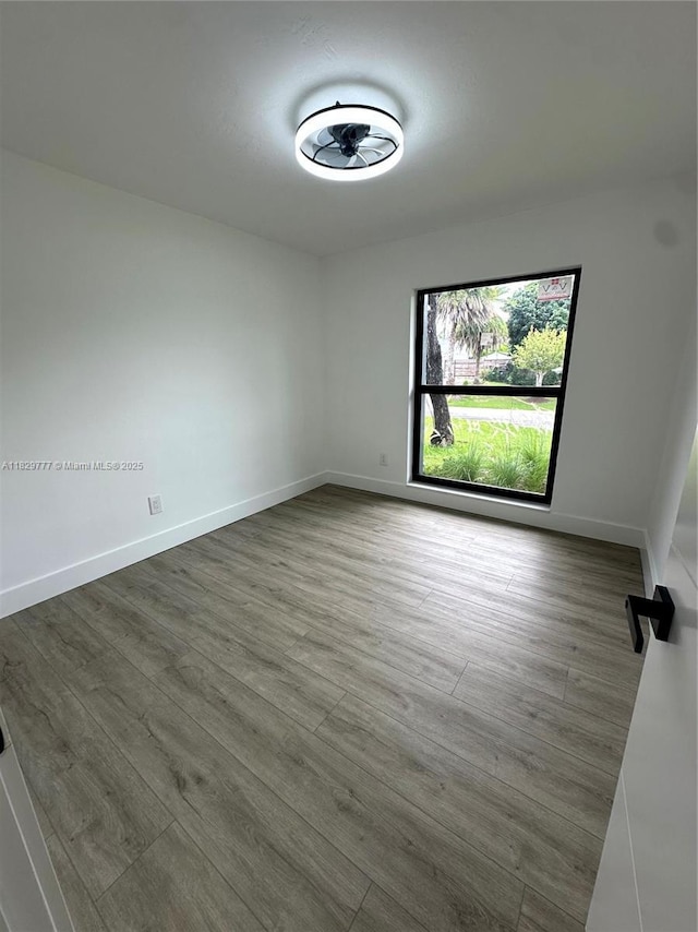 17902 SW 87th Pl, Palmetto Bay, FL 33157 - spare room featuring wood finished floors and baseboards