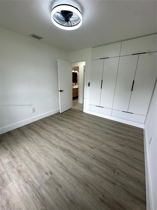 17902 SW 87th Pl, Palmetto Bay, FL 33157 - unfurnished bedroom with light wood finished floors and ensuite bathroom