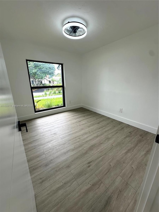17902 SW 87th Pl, Palmetto Bay, FL 33157 - unfurnished room with baseboards and wood finished floors
