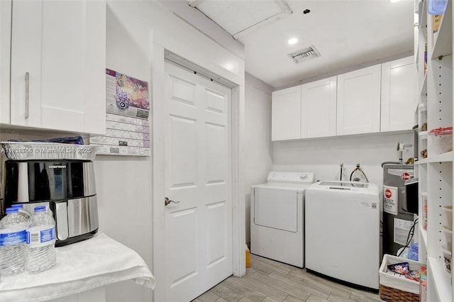 1840 N 56th Ave, Hollywood, FL 33021 - laundry room with cabinet space, electric water heater, washing machine and clothes dryer, light wood-style flooring, and recessed lighting
