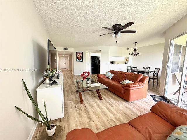 1400 SW 137th Ave Unit 411F, Pembroke Pines, FL 33027 - living area featuring light wood-style flooring, a ceiling fan, a textured ceiling, and a chandelier