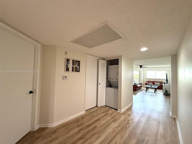 1400 SW 137th Ave Unit 411F, Pembroke Pines, FL 33027 - hallway with stacked washer / drying machine, light wood-type flooring, attic access, recessed lighting, and a textured ceiling