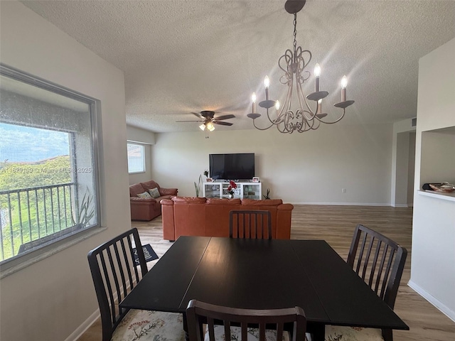 1400 SW 137th Ave Unit 411F, Pembroke Pines, FL 33027 - dining area with a textured ceiling, light wood-type flooring, a chandelier, and a ceiling fan