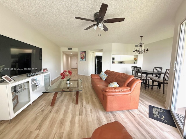 1400 SW 137th Ave Unit 411F, Pembroke Pines, FL 33027 - living area featuring light wood-style floors, a chandelier, a textured ceiling, and a ceiling fan
