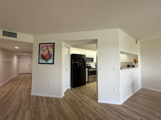 1400 SW 137th Ave Unit 411F, Pembroke Pines, FL 33027 - corridor with wood finished floors and a textured ceiling