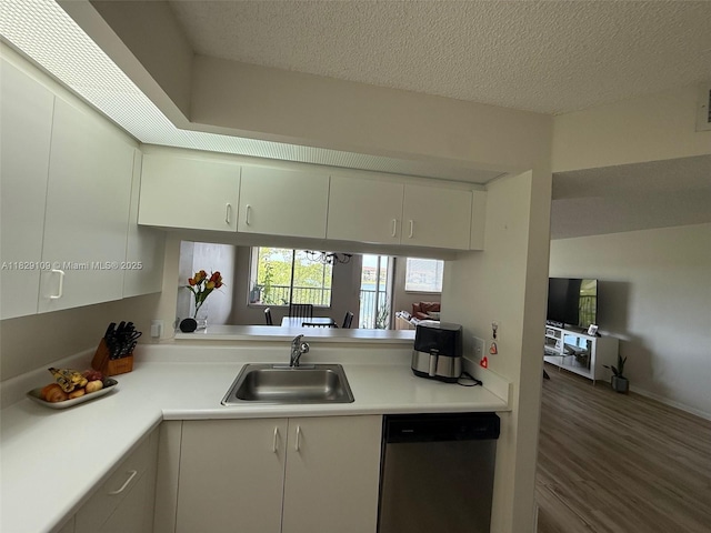 1400 SW 137th Ave Unit 411F, Pembroke Pines, FL 33027 - kitchen with stainless steel dishwasher, light countertops, wood finished floors, a textured ceiling, and white cabinetry