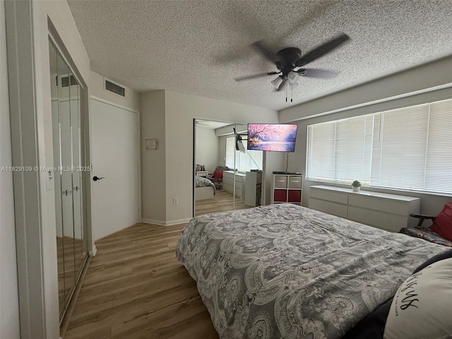 1400 SW 137th Ave Unit 411F, Pembroke Pines, FL 33027 - bedroom featuring wood finished floors, a textured ceiling, a closet, and ceiling fan