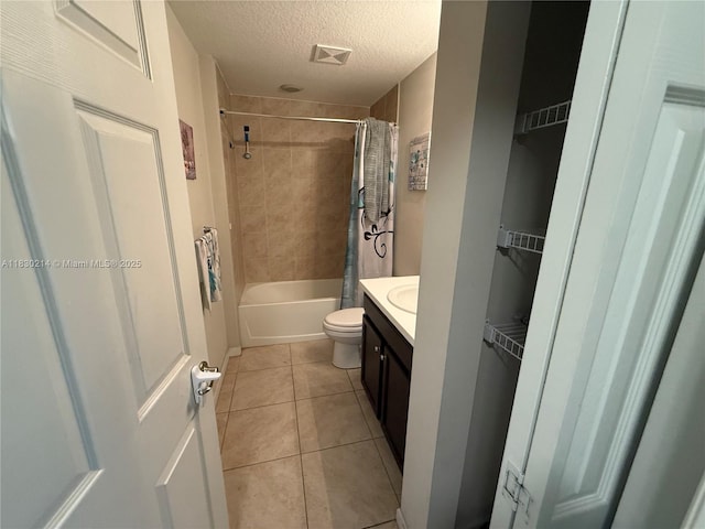 3574 SW Masilunas St, Port St Lucie, FL 34953 - bathroom featuring a textured ceiling, tile patterned flooring, vanity, and shower / tub combo