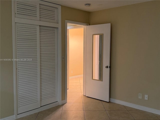3500 Harrison St Unit 10, Hollywood, FL 33021 - unfurnished bedroom with light tile patterned flooring and a closet