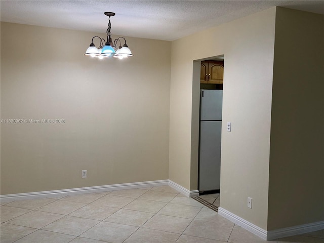 3500 Harrison St Unit 10, Hollywood, FL 33021 - unfurnished room with a chandelier, light tile patterned floors, and a textured ceiling