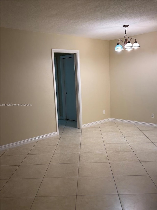 3500 Harrison St Unit 10, Hollywood, FL 33021 - unfurnished room with light tile patterned floors, a textured ceiling, and a chandelier