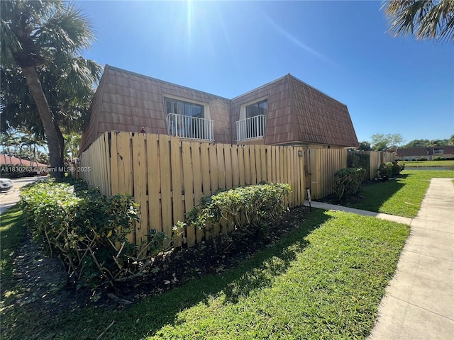 719 Mill Valley Pl, West Palm Beach, FL 33409 - view of home's exterior with mansard roof