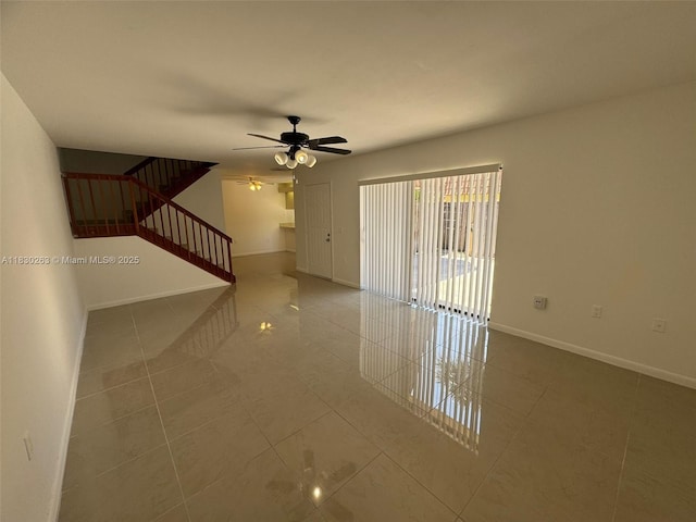 719 Mill Valley Pl, West Palm Beach, FL 33409 - empty room featuring tile patterned flooring, stairway, and ceiling fan