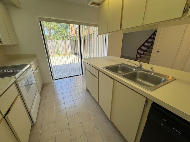 719 Mill Valley Pl, West Palm Beach, FL 33409 - kitchen featuring white electric stove, dishwasher, light countertops, and light tile patterned floors