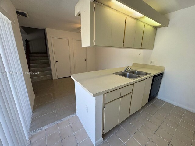 719 Mill Valley Pl, West Palm Beach, FL 33409 - kitchen with dishwashing machine, light tile patterned floors, and light countertops