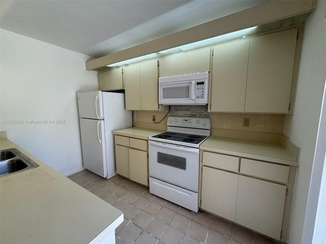 719 Mill Valley Pl, West Palm Beach, FL 33409 - kitchen featuring white appliances, tasteful backsplash, light countertops, and light tile patterned flooring