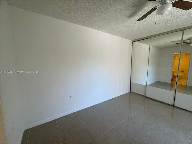 719 Mill Valley Pl, West Palm Beach, FL 33409 - unfurnished bedroom with a textured ceiling, a closet, ceiling fan, and tile patterned flooring
