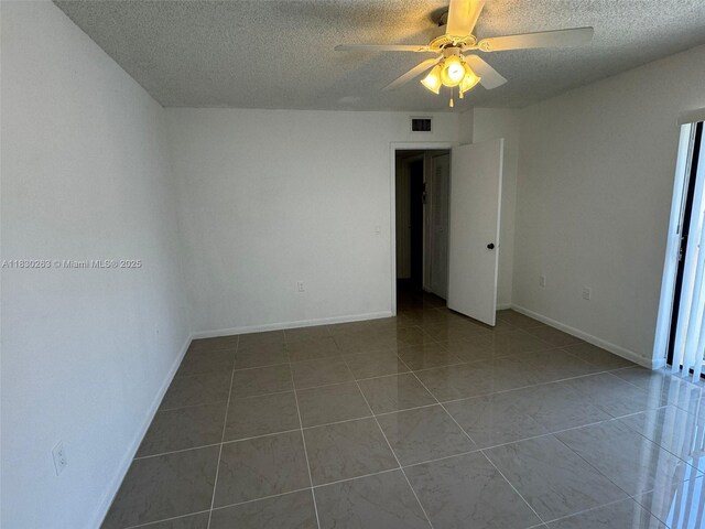 719 Mill Valley Pl, West Palm Beach, FL 33409 - spare room with a textured ceiling, a ceiling fan, and tile patterned flooring