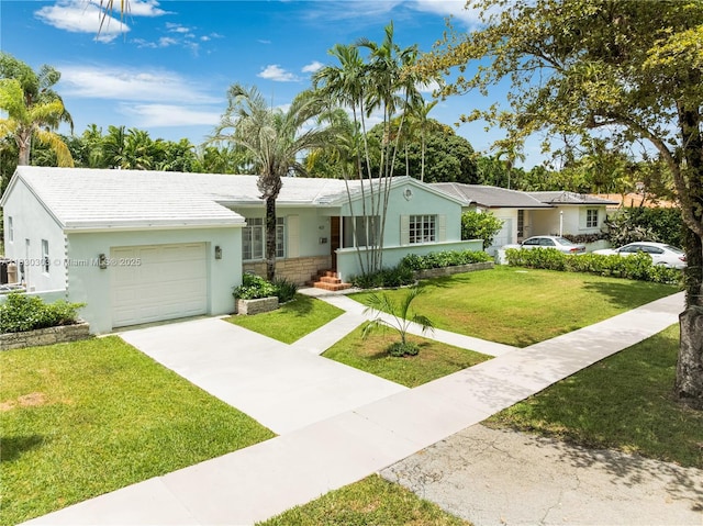 431 Gerona Ave, Coral Gables, FL 33146 - ranch-style house with an attached garage, driveway, stucco siding, and a front lawn