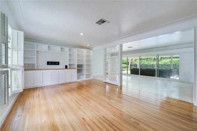 431 Gerona Ave, Coral Gables, FL 33146 - unfurnished living room with light wood-style flooring, french doors, built in shelves, and recessed lighting