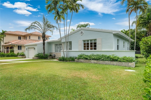 431 Gerona Ave, Coral Gables, FL 33146 - view of front of house with stucco siding, an attached garage, a front yard, and a tile roof
