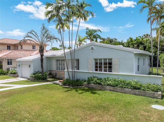 431 Gerona Ave, Coral Gables, FL 33146 - view of front of house with stucco siding, a garage, a front lawn, and concrete driveway