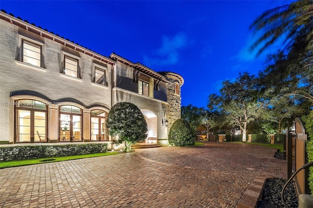 10101 SW 60th Ct, Pinecrest, FL 33156 - view of front of home featuring stucco siding, curved driveway, and french doors