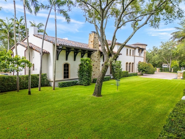 10101 SW 60th Ct, Pinecrest, FL 33156 - view of front facade with a chimney, stucco siding, and a tiled roof